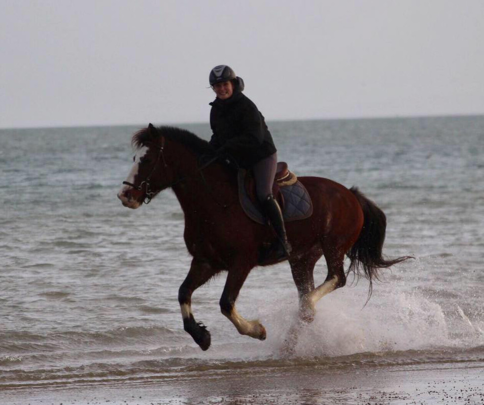 Sophie Gauthier on horseback on the beach on a tour with Cheval et Chateaux